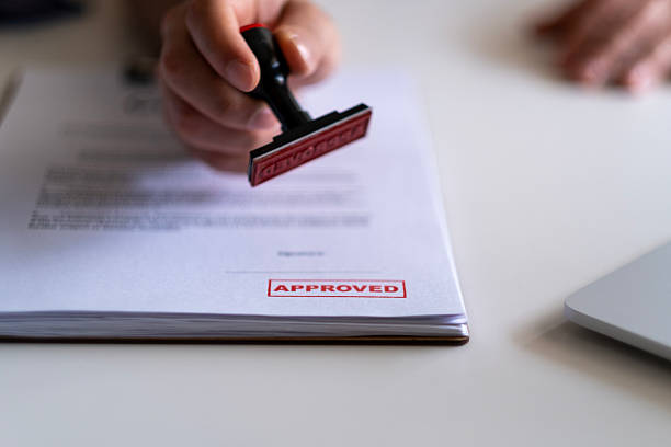 c5 Lending concept. Pre-approved mortgage loan. Business Man Stamping With Approved Stamp On Document. Business approve Stamp and certificate concept. Businessman Hands Stamping a document