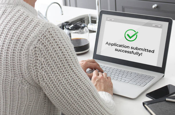 Man submitting an application online. Man submitting an application online.